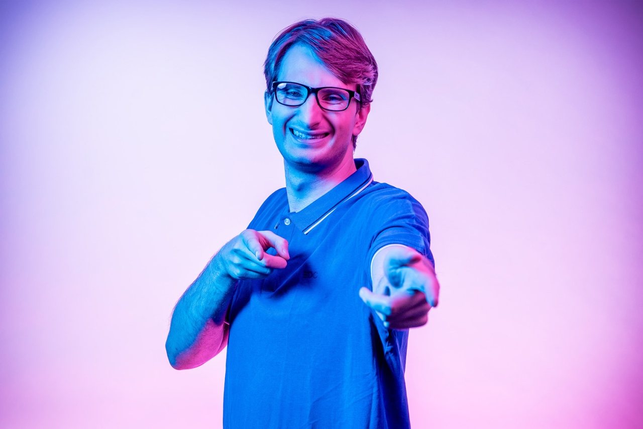 Man points forward with both hands