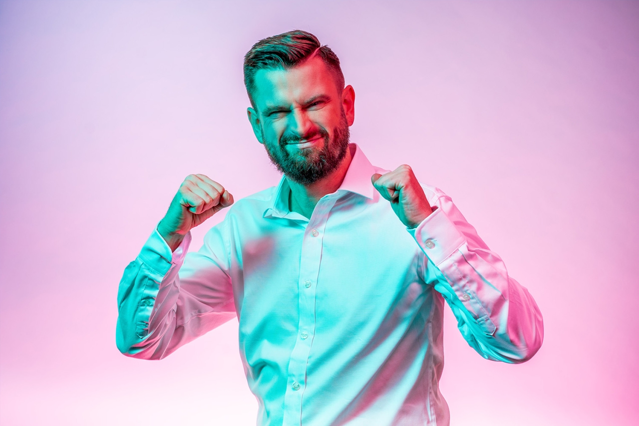 Man happily clenched his hands into a fist