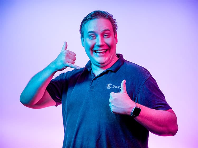 Man shows thumbs up and forms phone with the other hand